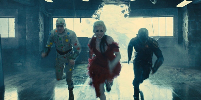 David Dastmalchian, Margot Robbie and Idris Elba in `` The Suicide Squad, '' which hits theaters and HBO Max on August 6.