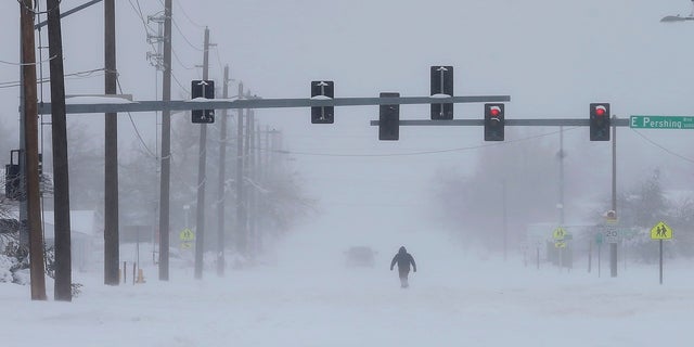 A person trudges across Ridge Road in east Cheyenne, Wyo., on Sunday. (AP/Wyoming Tribune Eagle)