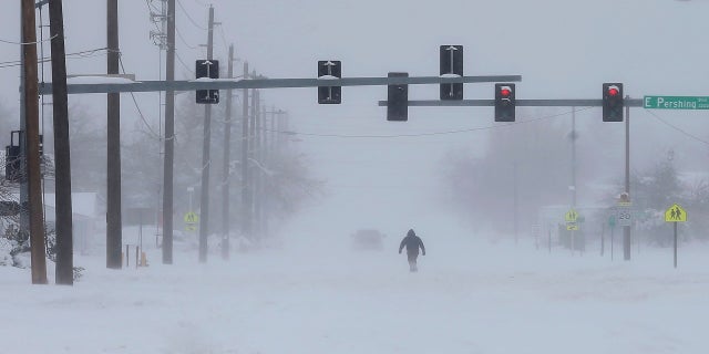 A person trudges across Ridge Road in east Cheyenne, Wyo., on Sunday. (AP/Wyoming Tribune Eagle)