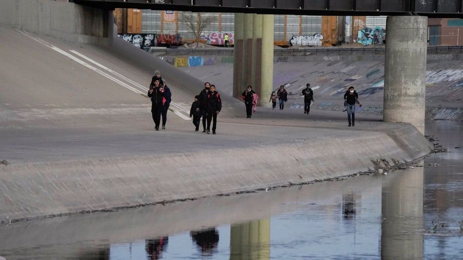 Migrants cross the border into El Paso, Texas, U.S.,