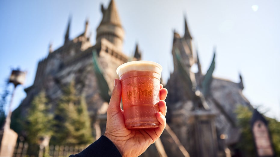 Butterbeer held up to sky