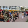 Despite the coronavirus, spring breakers return to South Beach and walk along Ocean Drive that is closed to traffic on Thursday, March 12, 2021. Miami Beach officials are imposing an emergency 8 p.m.-6 a.m. curfew effective immediately, saying large, out-of-control spring break crowds crammed the beaches, trashed some restaurant properties and brawled in the streets. Tourists and hotel guests are being told to stay indoors during the curfew hours. (Al Diaz/Miami Herald via AP)
