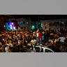 Crowds defiantly gather in the street while a speaker blasts music an hour past curfew in Miami Beach, Florida, on Sunday. An 8 p.m. curfew has been extended in Miami Beach after law enforcement worked to contain unruly crowds of spring break tourists. (AP/Miami Herald)