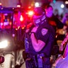 Miami Beach police arrive on the scene to disperse a crowd that formed near Seventh Street and Alton Road, after crowds were sent away from Ocean Drive in Miami Beach, Florida, on Sunday, March 21, 2021. An 8 p.m. curfew has been extended in Miami Beach after law enforcement worked to contain unruly crowds of spring break tourists. (Daniel A. Varela/Miami Herald via AP)