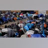 A makeshift camp of migrants sits at the border port of entry leading to the United States, Wednesday, March 17, 2021, in Tijuana, Mexico. The migrant camp shows how confusion has undercut the message from President Joe Biden that it’s not the time to come to the United States. Badly misinformed, some 1,500 migrants set up tents across the border from San Diego harbor in the hope that Biden will open entry briefly and without notice. (AP Photo/Gregory Bull)