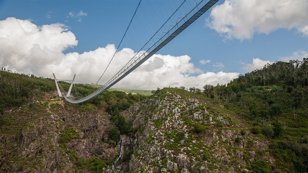 The bridge traverses the fast moving River Paiva in the Arouca Geopark, suspended 574 feet above the water.