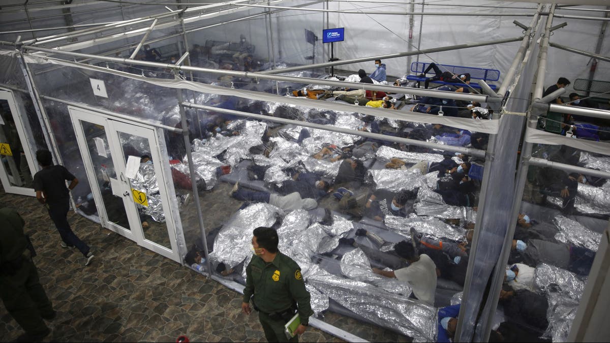 Young minors lie inside a pod at the Donna Department of Homeland Security holding facility, the main detention center for unaccompanied children in the Rio Grande Valley run by U.S. Customs and Border Protection in Donna, Texas. (AP Photo/Dario Lopez-Mills,Pool)