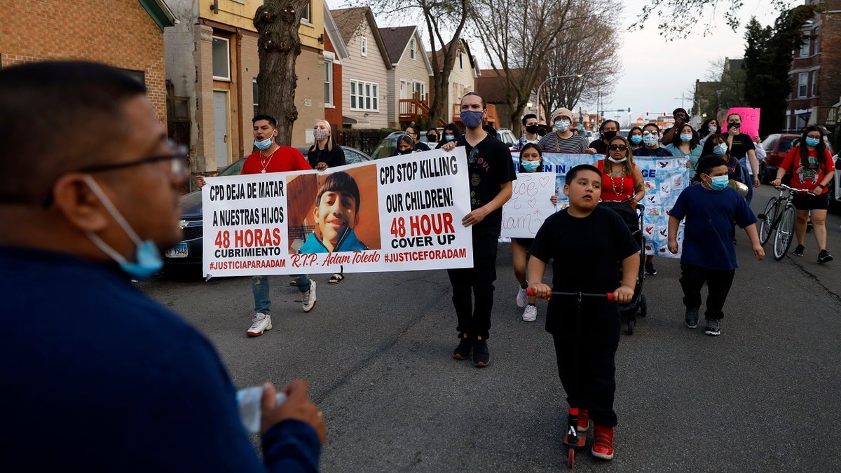 Members of Chicago's Little Village Community Council march on Tuesday, April 6, 2021 to protest against the death of 13-year-old Adam Toledo, who was shot by a Chicago Police officer at about 2 a.m. on March 29 in an alley west of the 2300 block of South Sawyer Avenue near Farragut Career Academy High School. (AP Photo/Shafkat Anowar)