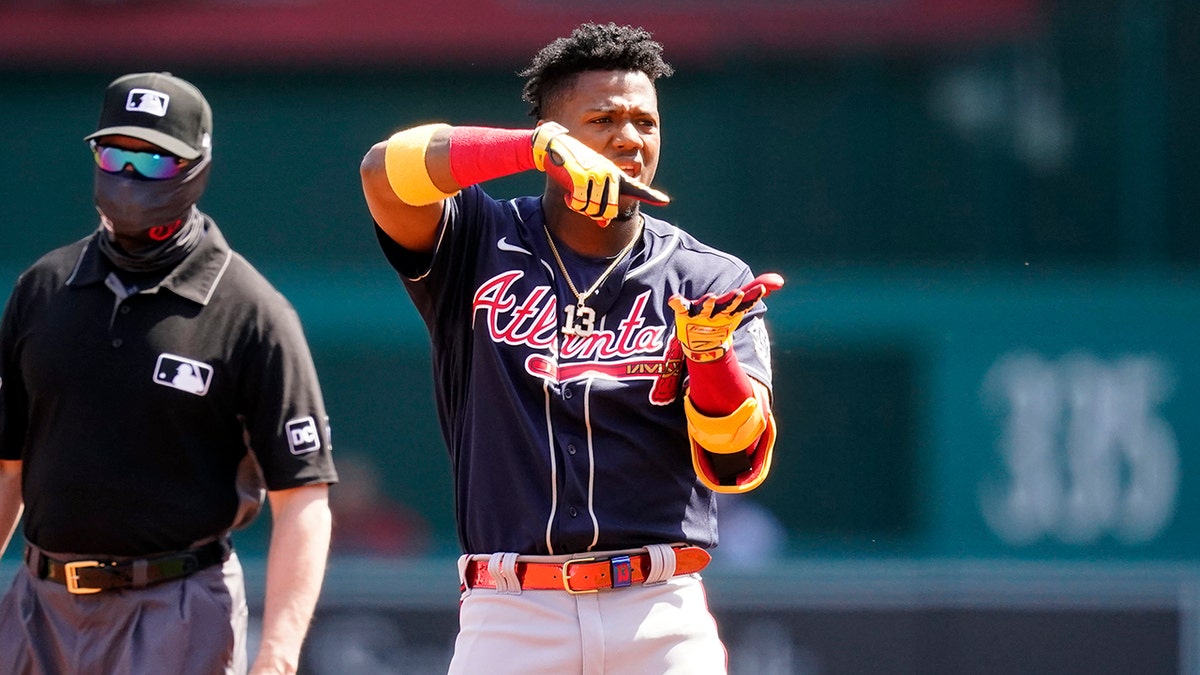 Atlanta Braves' Ronald Acuna Jr. celebrates his double during the first inning in the first baseball game of a doubleheader against the Washington Nationals at Nationals Park, Wednesday, April 7, 2021, in Washington.