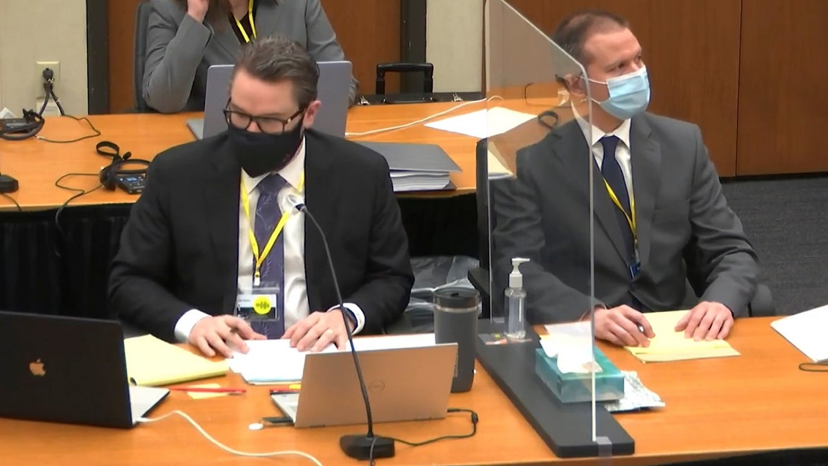 In this image from video, defense attorney Eric Nelson, left, and defendant, former Minneapolis police Officer Derek Chauvin, right, listen as Hennepin County Judge Peter Cahill presides Thursday April 8, 2021, in the trial of Chauvin at the Hennepin County Courthouse in Minneapolis, Minn. (Court TV via AP, Pool)