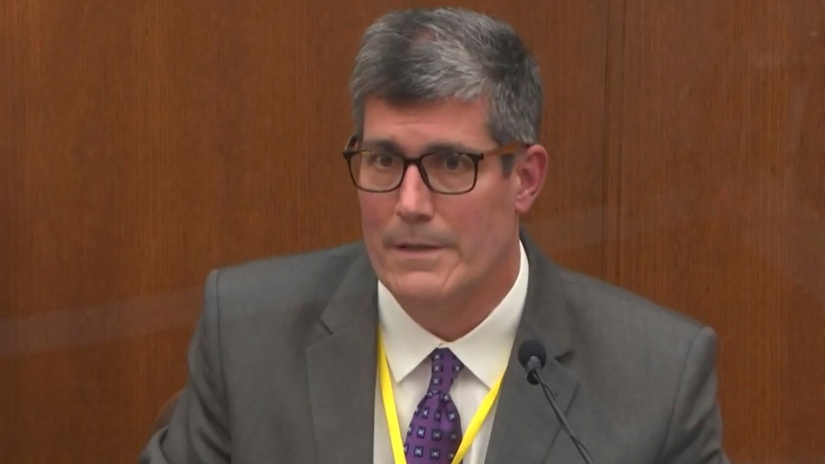 In this image from video, Dr. Andrew Baker, Hennepin County Medical Examiner, testifies as Hennepin County Judge Peter Cahill presides Friday, April 9, 2021, in the trial of former Minneapolis police Officer Derek Chauvin at the Hennepin County Courthouse in Minneapolis, Minn. (Court TV via AP, Pool)