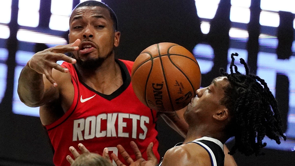 Los Angeles Clippers guard Terance Mann, right, loses control of the ball while under pressure from Houston Rockets forward Sterling Brown during the second half of an NBA basketball game Friday, April 9, 2021, in Los Angeles. (AP Photo/Mark J. Terrill)