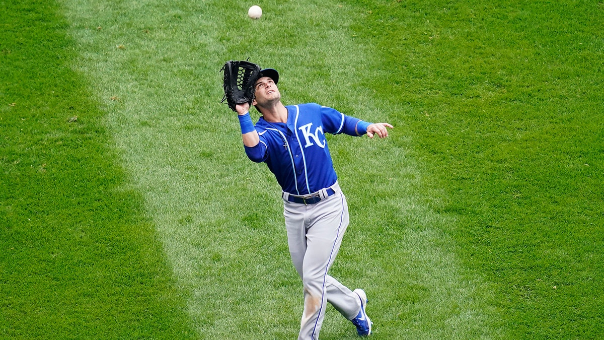 Kansas City Royals left fielder Andrew Benintendi catches a fly ball by Chicago White Sox's Luis Robert during the fourth inning of a baseball game in Chicago, Sunday, April 11, 2021. (AP Photo/Nam Y. Huh)