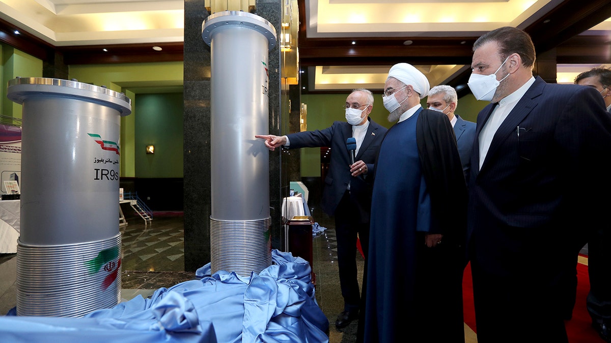 Iran Nuclear inspection Hassan Rouhani points at a centrifuge with advisors looking on