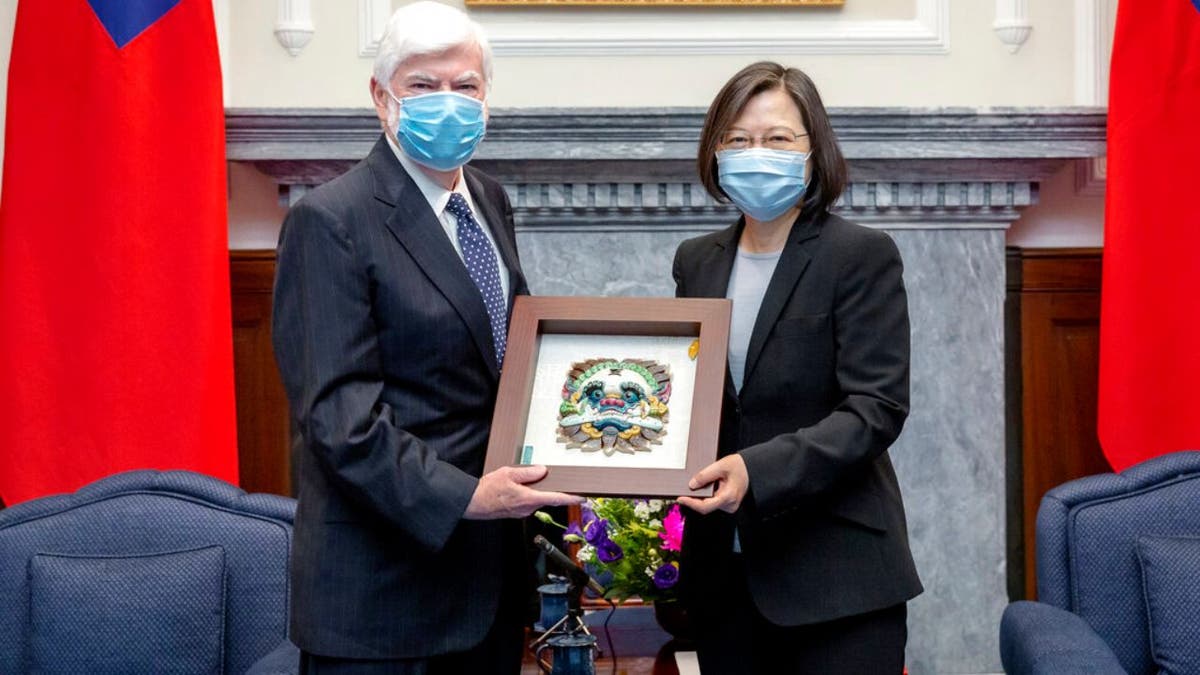 In this photo released by the Taiwan Presidential Office, Taiwan President Tsai Ing-wen, right, poses for photos with former U.S. senator Chris Dodd during a meeting in Taipei, Taiwan on Thursday, April 15, 2021. (Taiwan Presidential Office via AP)