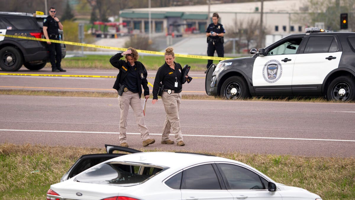 Two Bureau of Criminal Apprehension agents begin investigating the scene of an officer-involved shooting, Sunday, April 18, 2021, in Burnsville, Minn. 