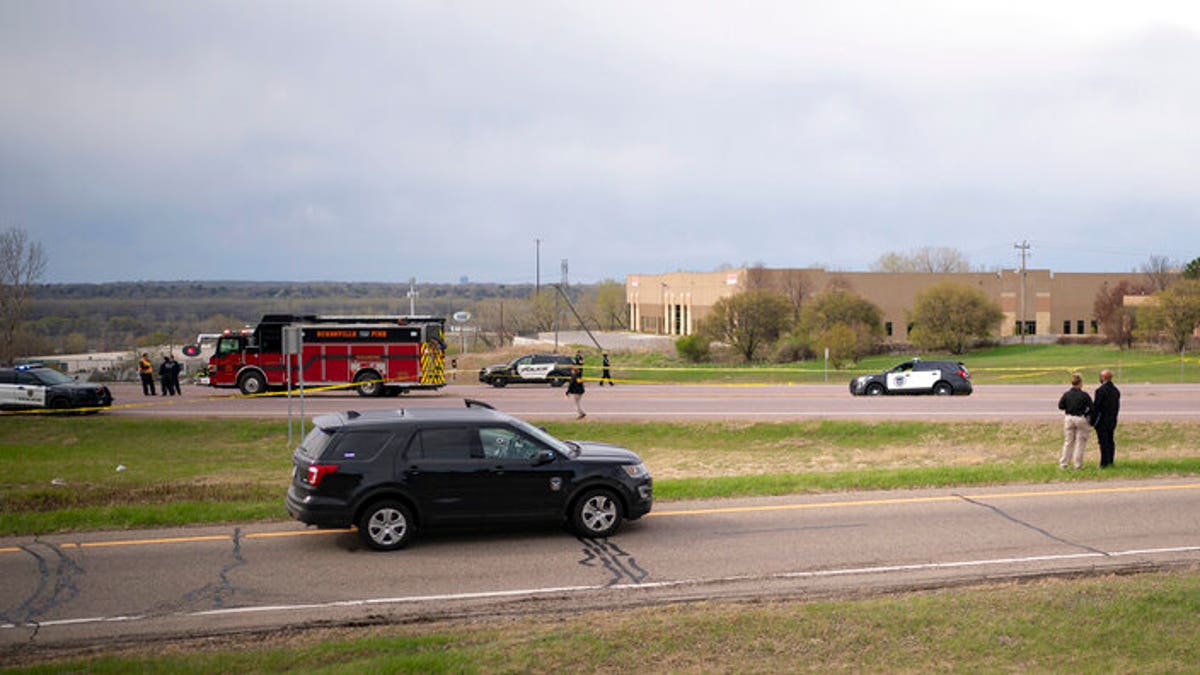 Authorities investigate the scene of an officer-involved shooting Sunday, April 18, 2021, in Burnsville, Minn. 