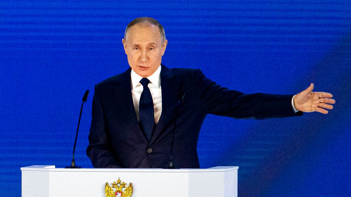 Russian President Vladimir Putin gestures as he gives his annual state of the nation address in Manezh, Moscow on Wednesday, April 21, 2021.