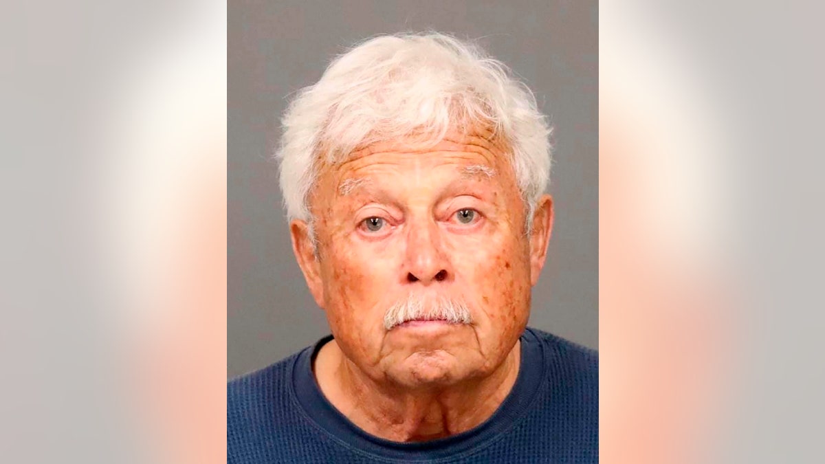 White-haired Ruben Flores stares blankly in a mugshot