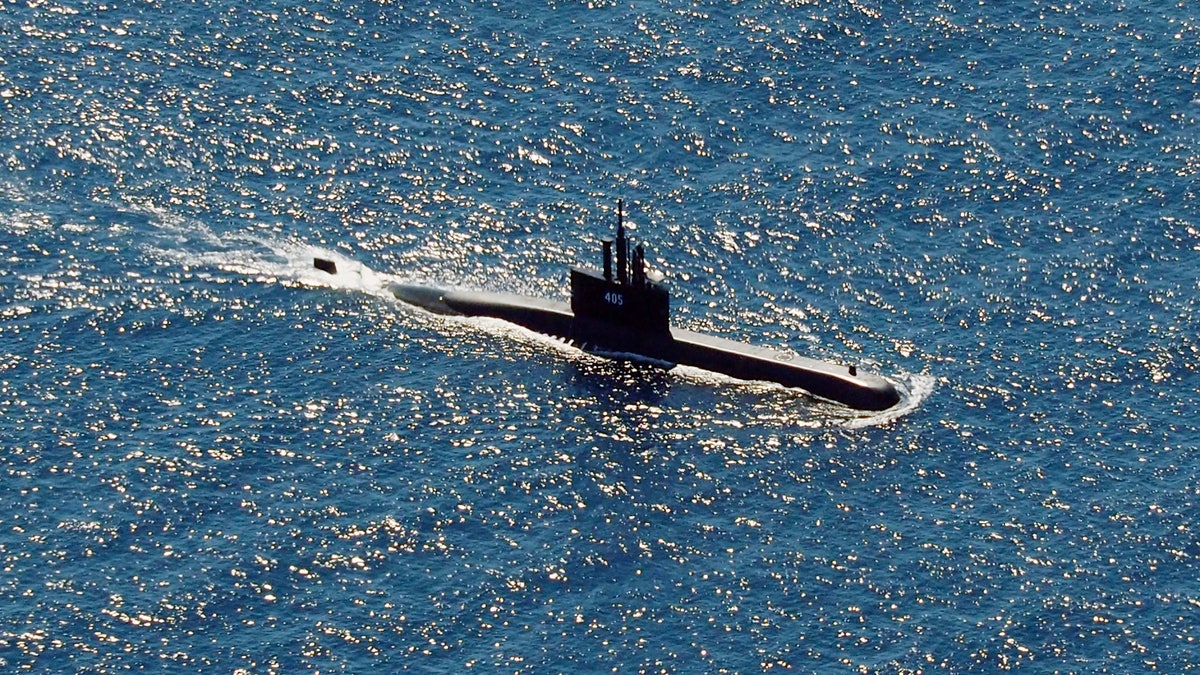 In this aerial photo taken from a maritime patrol aircraft of 800 Air Squadron of the 2nd Air Wing of Naval Aviation Center (PUSPENERBAL), the Indonesian Navy submarine KRI Alugoro sails during a search for KRI Nanggala, another submarine that went missing while participating in a training exercise on Wednesday, in the waters off Bali Island, Indonesia, Thursday, April 22, 2021. (AP Photo/Eric Ireng)