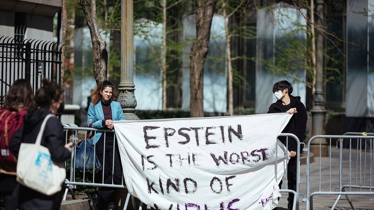 Activists protesting Jeffrey Epstein's associate Ghislaine Maxwell stand in front of a federal court in New York City. (AP Photo/Kevin Hagen)