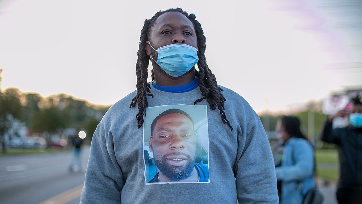 A demonstrator wears a shirt with an image of Andrew Brown Jr. on it during a march, Thursday, April 22, 2021, Elizabeth City, N.C., in reaction to the death of Brown, who was shot and killed by a Pasquotank County sheriff's deputy earlier in the week. (Robert Willett/The News & Observer via AP)