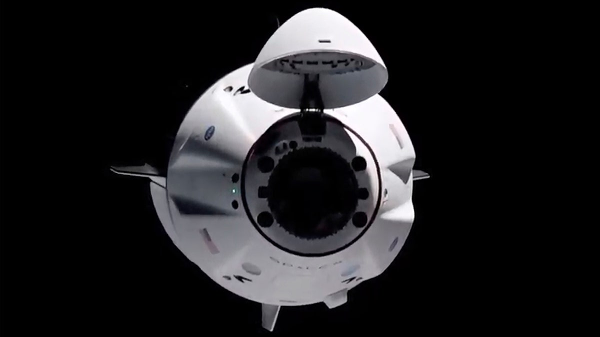 In this image made from NASA TV, the SpaceX Crew Dragon spacecraft is seen from the international space station, Saturday, April 24, 2021. The recycled SpaceX capsule carrying four astronauts has arrived at the International Space Station, a day after launching from Florida. (NASA via AP)