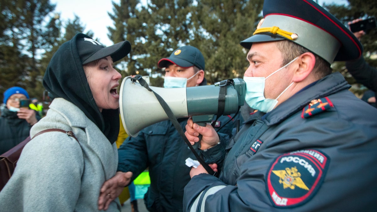 FILE - A woman argues with police officer during a protest in support of jailed opposition leader Alexei Navalny in Ulan-Ude, the regional capital of Buryatia, a region near the Russia-Mongolia border, Russia, in this Wednesday, April 21, 2021, file photo. (AP Photo/Anna Ogorodnik, File)