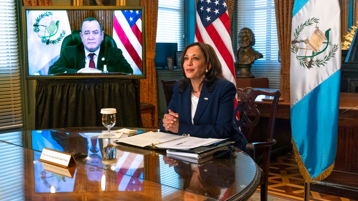 Vice President Kamala Harrismeets virtually with Guatemala's President Alejandro Giammattei, seen on screen at left, Monday, April 26, 2021, from her ceremonial office at the Eisenhower Executive Office Building on the White House complex in Washington. (AP Photo/Jacquelyn Martin)
