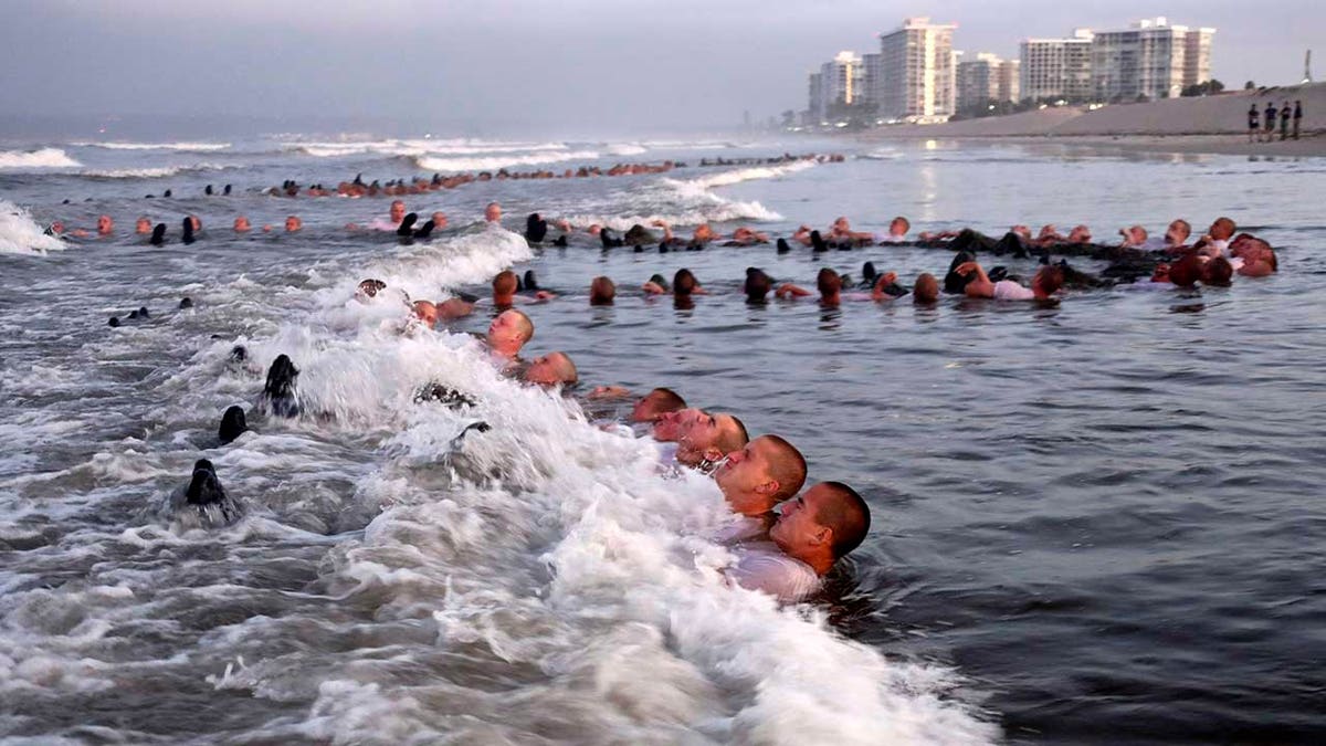 U.S. Navy SEAL candidates participating in "surf immersion" during Basic Underwater Demolition/SEAL training at the Naval Special Warfare Center in Coronado, California, May 4, 2020. U.S. Navy SEALs are undergoing a major transition to improve leadership and expand their commando capabilities. (MC1 Anthony Walker/U.S. Navy via AP)