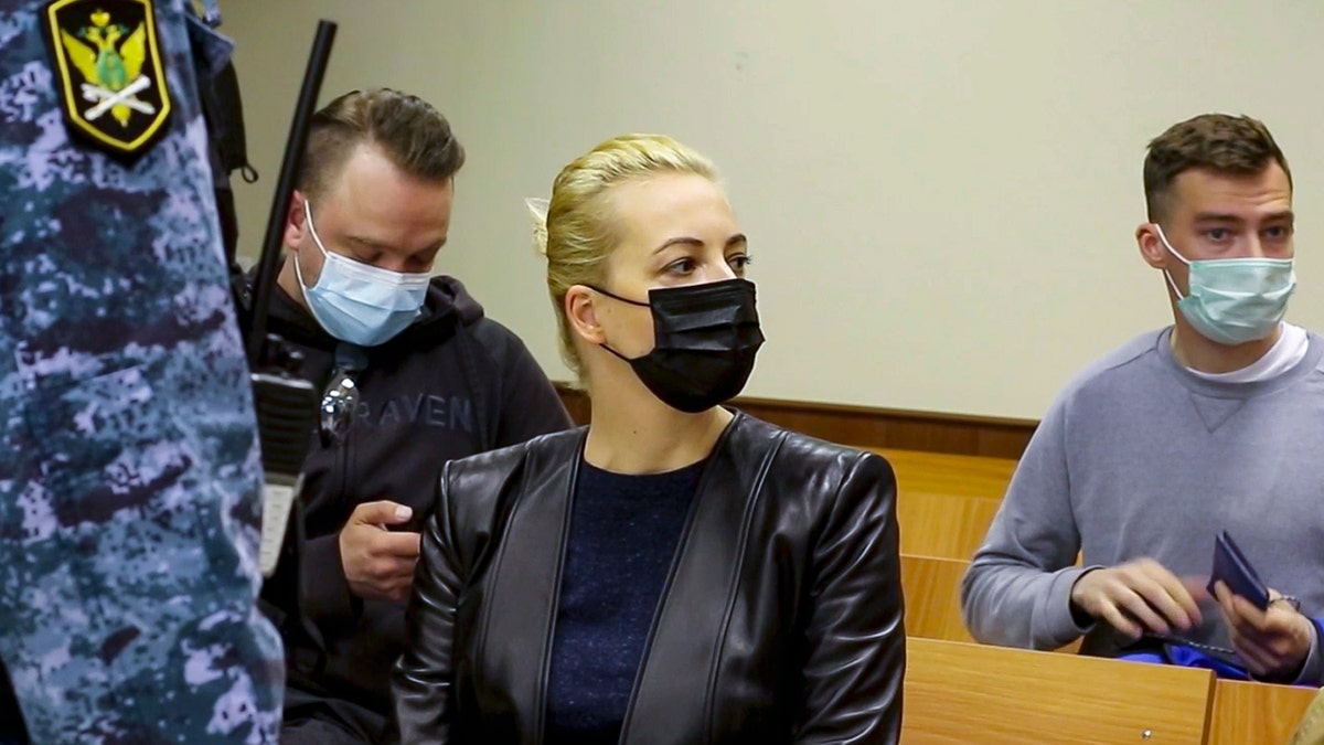 In this photo taken from a video provided by the Babuskinsky District Court on Thursday, April 29, 2021, Wife of Russian opposition leader Alexei Navalny, Yulia, centre, attends a court session with Russian opposition leader Alexei Navalny in the Babuskinsky District Court in Moscow, Russia. Navalny appeared in court via videolink from prison Thursday for an appeal against his conviction and fine for defaming a World War II veteran. Navalny was convicted in February and ordered to pay a fine of 850,000 rubles, or $11,500. (Babuskinsky District Court Press Service via AP)