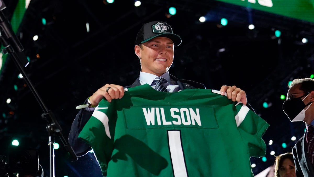 BYU quarterback Zach Wilson holds a New York Jets jersey after being selected second overall in the first round of the NFL football draft Thursday, April 29, 2021, in Cleveland. (AP Photo/Tony Dejak)