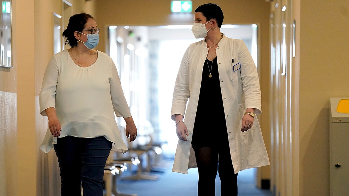 April 14, 2021: Joerdis Frommhold, right, head doctor of the 'MEDIAN Clinic Heiligendamm', speaks with patient Simone Ravera, left, after an interview with the Associated Press.