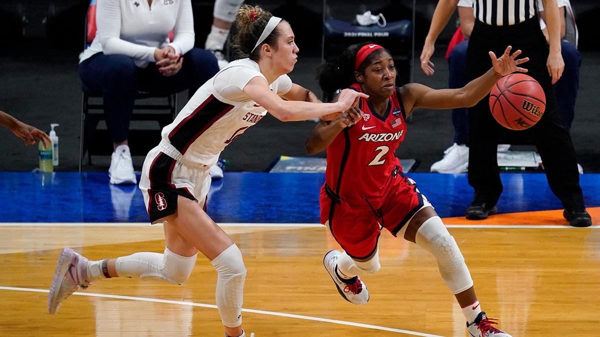 Arizona guard Aari McDonald (2) drives past Stanford guard Lexie Hull, left, during the second half of the championship game in the women's Final Four NCAA college basketball tournament, Sunday, April 4, 2021, at the Alamodome in San Antonio. (AP Photo/Eric Gay)