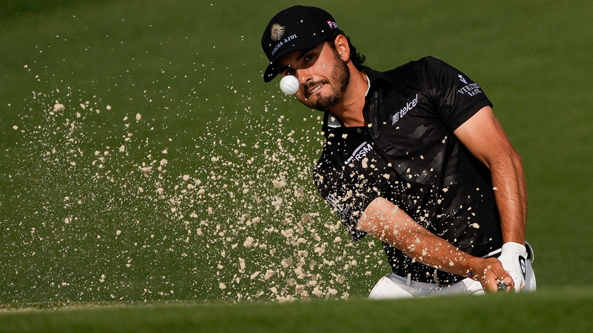 Abraham Ancer hits the ball out of a bunker in the first round