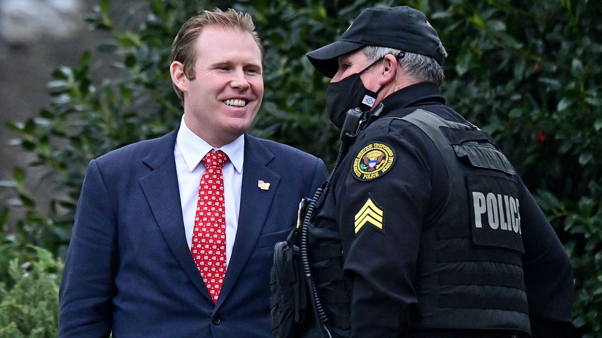 FILE - Andrew Giuliani, special assistant to President Trump and son of Rudy Giuliani, speaks to a Secret Service officer outside the West Wing of the White House in Washington, Jan. 15, 2021. REUTERS/Erin Scott