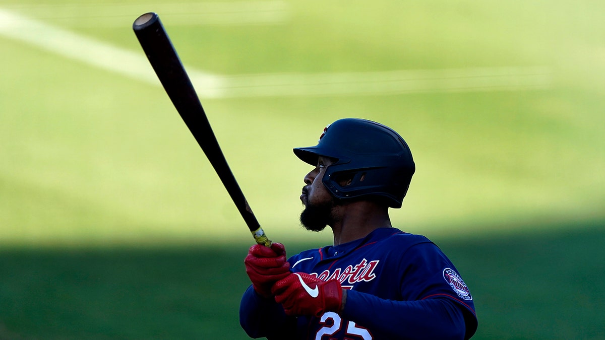 Minnesota Twins' Byron Buxton follows through on a three-run double during the first inning of the team's spring training baseball game against the Boston Red Sox on Thursday, March 25, 2021, in Fort Myers, Fla. (AP Photo/John Bazemore)