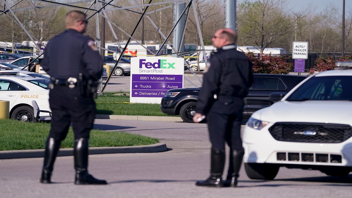 Police stand near the scene in Indianapolis where multiple people were shot at a FedEx Ground facility. (AP)