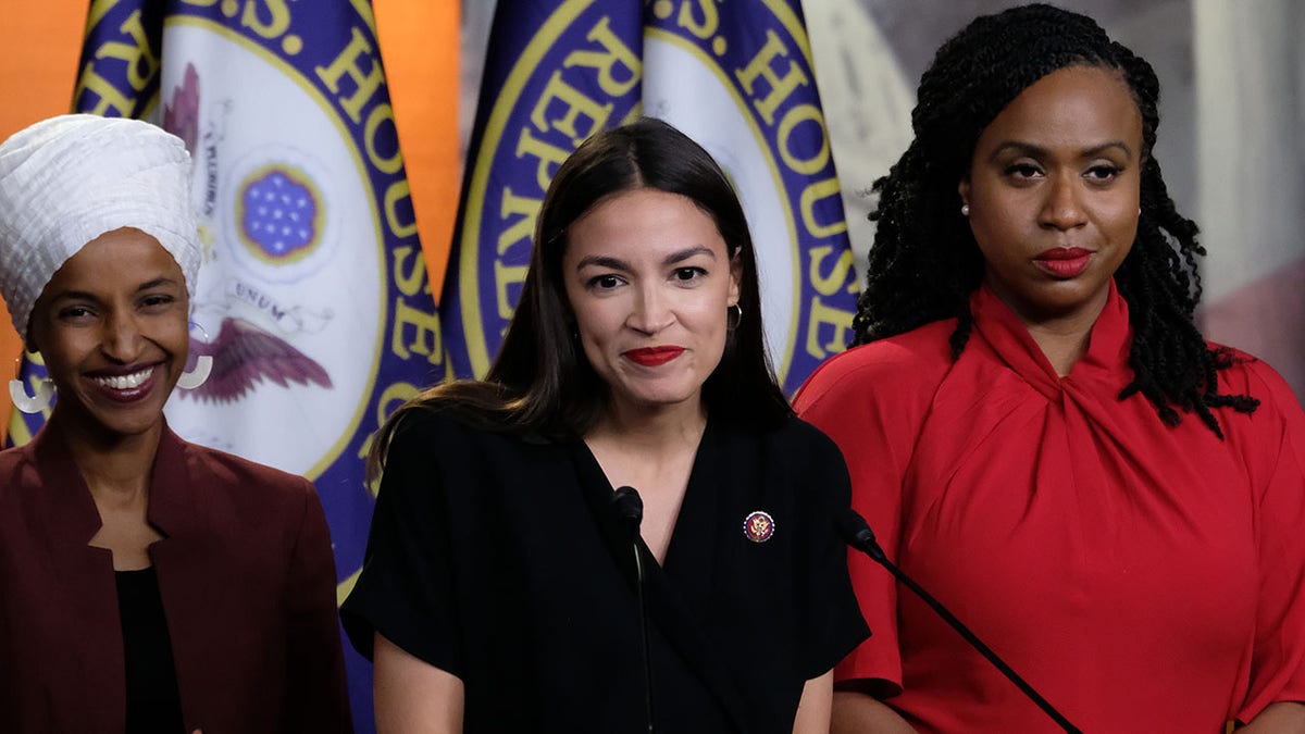 WASHINGTON, DC - JULY 15: U.S. Rep. Alexandria Ocasio-Cortez (D-NY) pauses while speaking as Reps. Ilhan Omar (D-MN) and Ayanna Pressley (D-MA) listen during a news conference at the U.S. Capitol on July 15, 2019 in Washington, DC. President Donald Trump stepped up his attacks on the four progressive Democratic congresswomen, saying that if they're not happy in the U.S. "they can leave." (Photo by Alex Wroblewski/Getty Images)