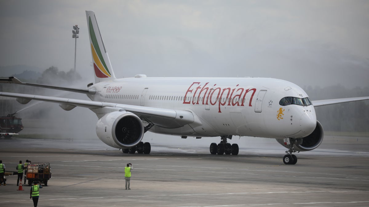Officials spray disinfectant on an Ethiopian Airlines plane in this September 2020 photo.