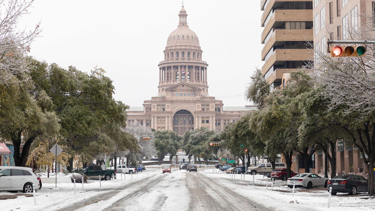 A snow-covered road near the Texas State Capitol Building in Austin, Texas, U.S., on Wednesday, Feb. 17, 2021. Photographer: Thomas Ryan Allison/Bloomberg via Getty Images