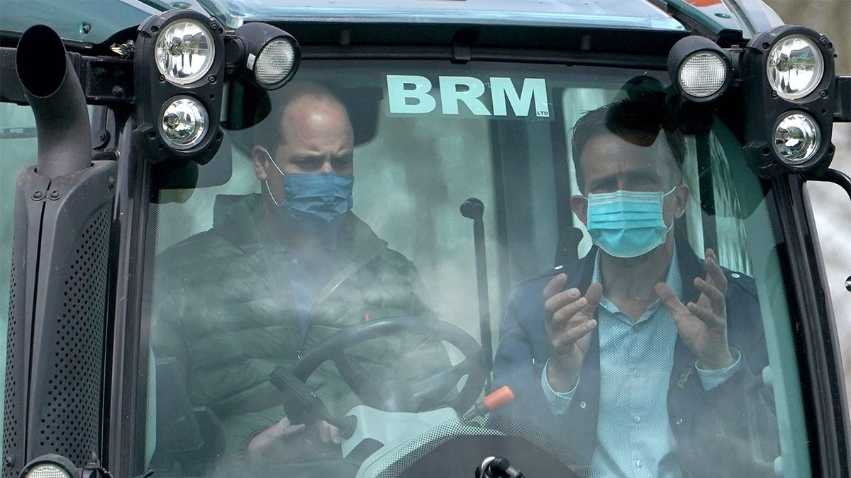 Farmer Stewart Chapman gives Prince William, Duke of Cambridge instructions on how to drive a tractor during a visit to Manor Farm in Little Stainton, Durham on April 27, 2021, in Darlington, England. 