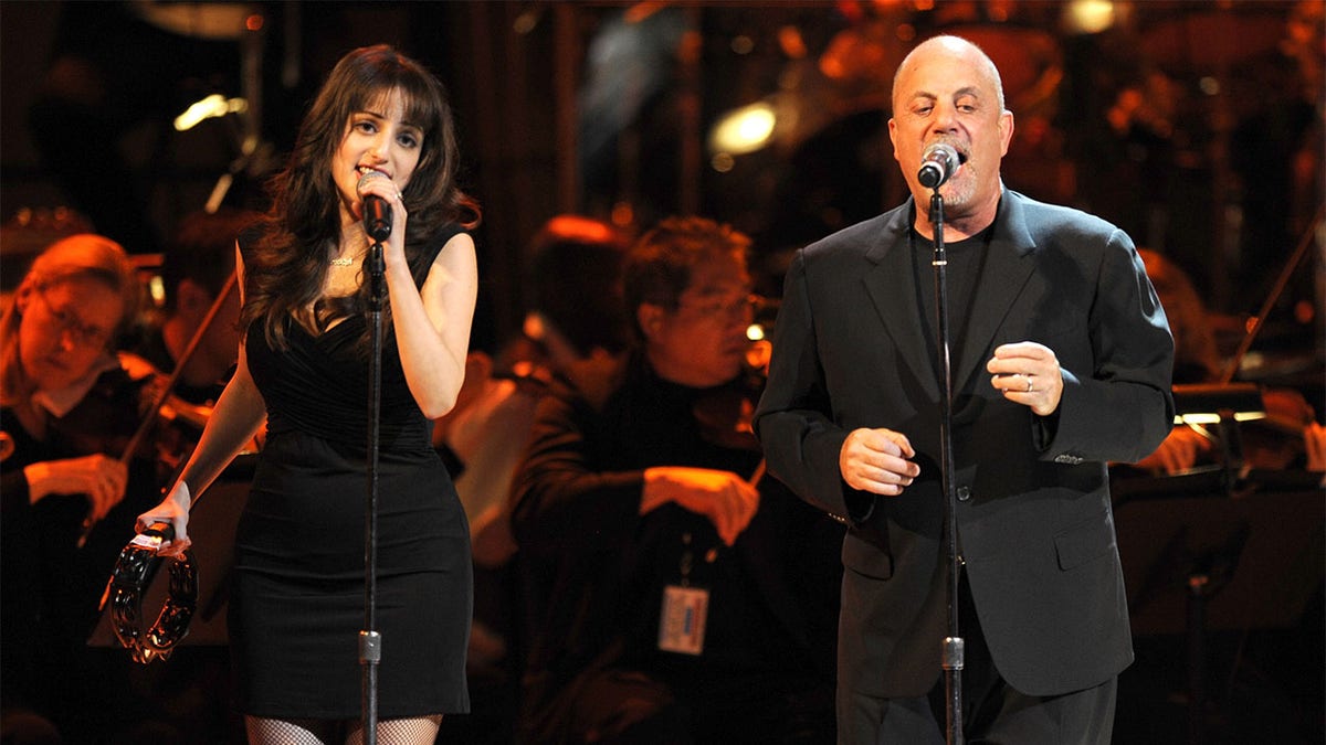 Alexa Ray Joel performing with Billy Joel.