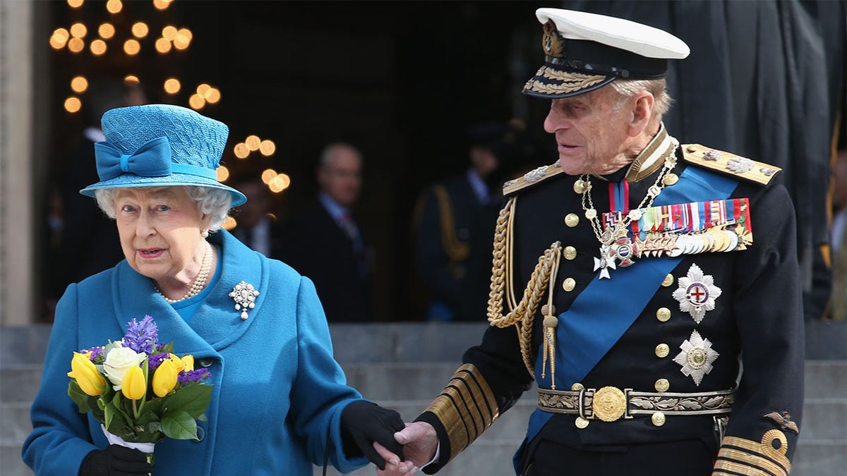 Prince Philip, Duke of Edinburgh (R) and Queen Elizabeth II depart a Service of Commemoration for troops who were stationed in Afghanistan, March 13, 2015.