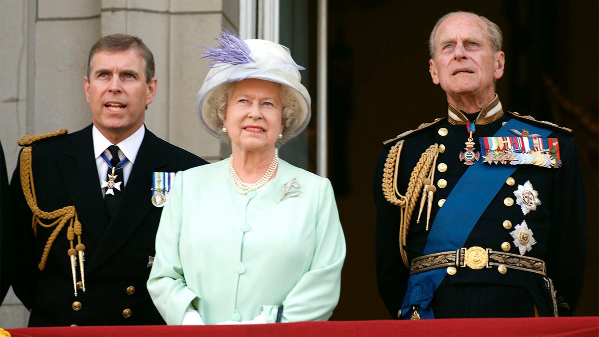 Queen Elizabeth ll, Prince Andrew, Duke of York and Prince Phillip, Duke of Edinburgh watch the flypast over the Mall of British and US World War 11 aircraft from the balcony of Buckingham Palace on National Commemoration Day July 10, 2005.
