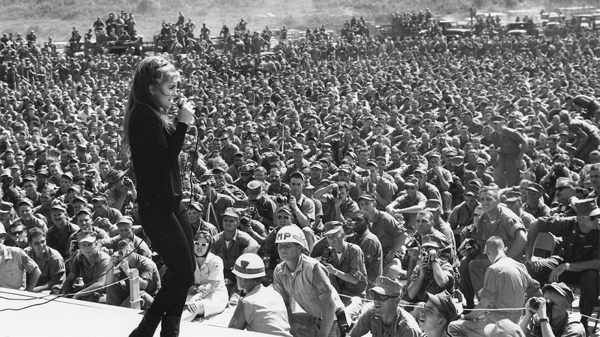 Thousands of service personnel listen to Ann-Margret sing one of her numbers during a show in Vietnam, circa 1966.