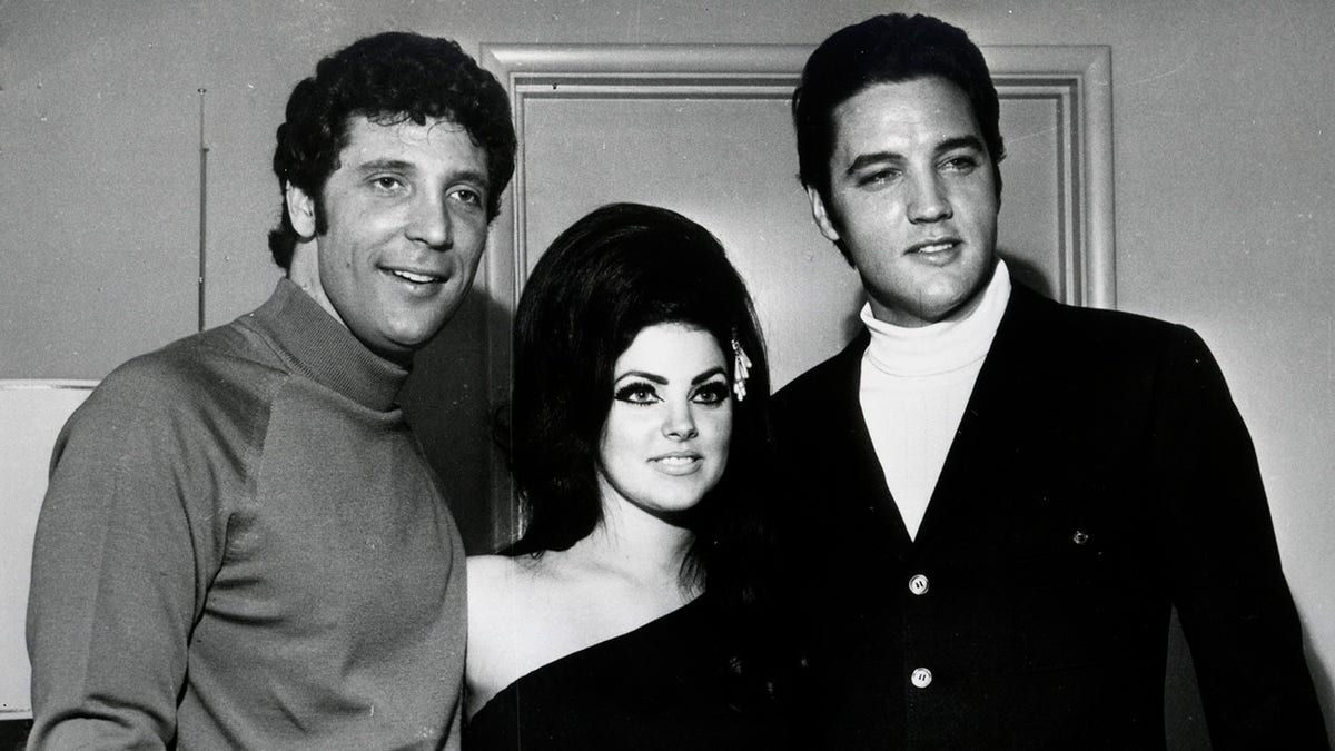  Elvis Presley (R) and Tom Jones pose for a portrait with Elvis' wife Priscilla Beaulieu Presley on April 7, 1968, in Las Vegas, Nevada. 