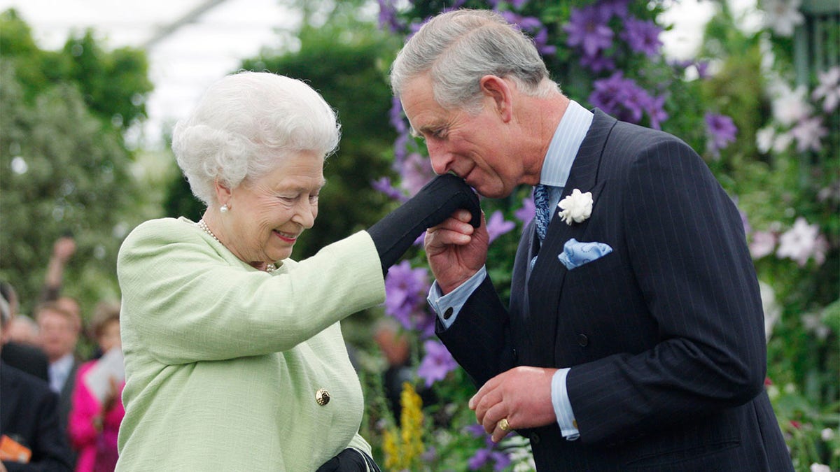 Queen Elizabeth II with her eldest son Prince Charles who is heir to the throne.