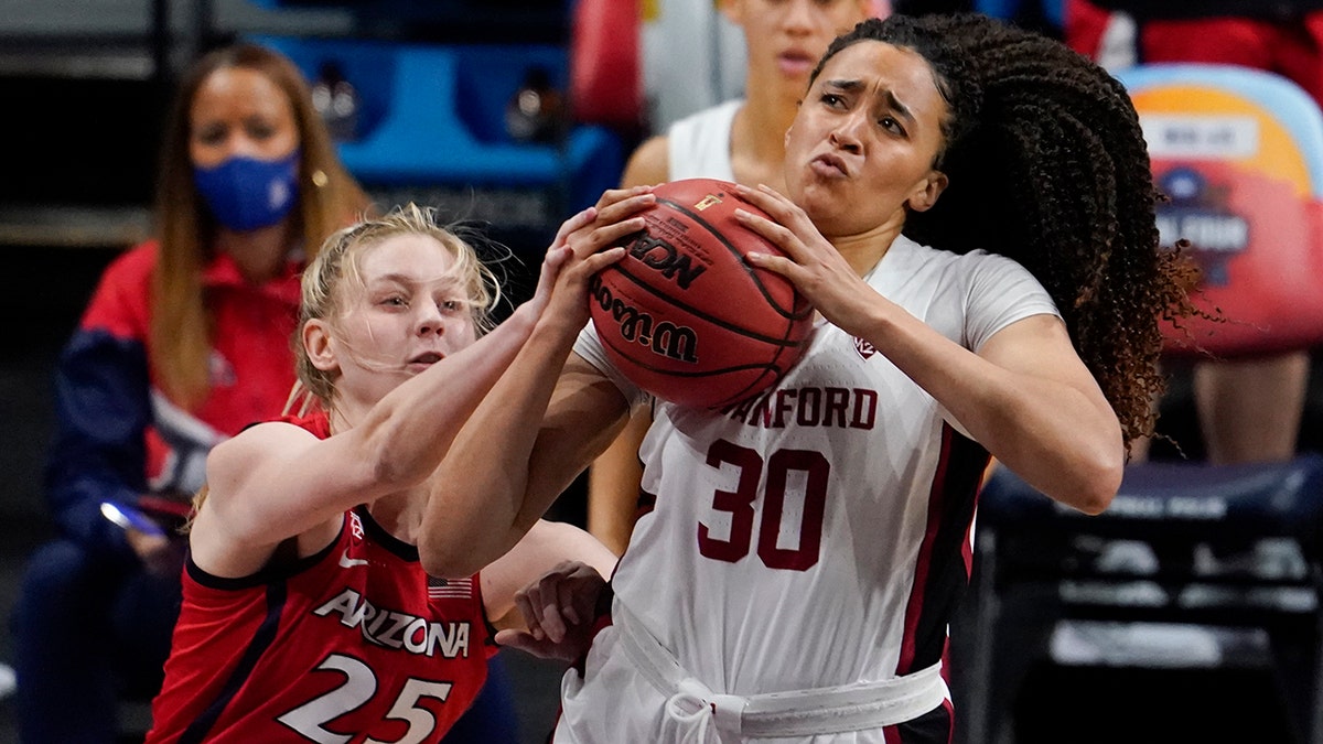 Stanford guard Haley Jones (30) drives to the basket over Arizona forward Cate Reese (25) during the first half of the championship game in the women's Final Four NCAA college basketball tournament, Sunday, April 4, 2021, at the Alamodome in San Antonio. (AP Photo/Eric Gay)