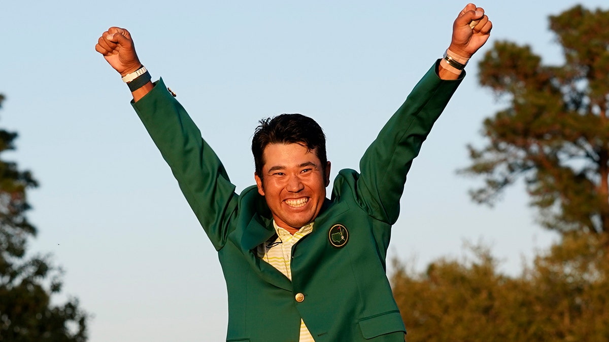 Hideki Matsuyama, of Japan, celebrates after putting on the champion's green jacket after winning the Masters golf tournament on Sunday, April 11, 2021, in Augusta, Ga.